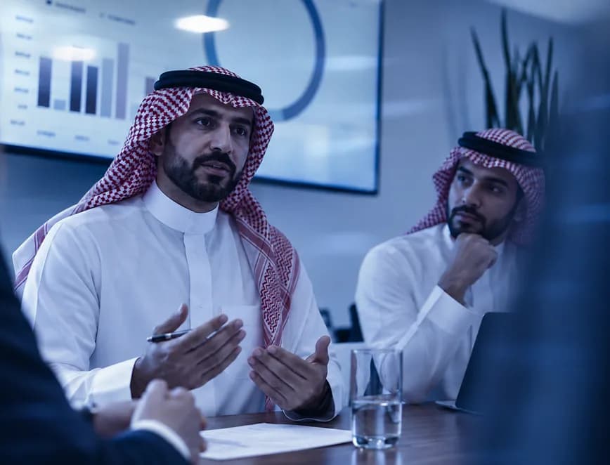 Two advisers shaking hands after a meeting.